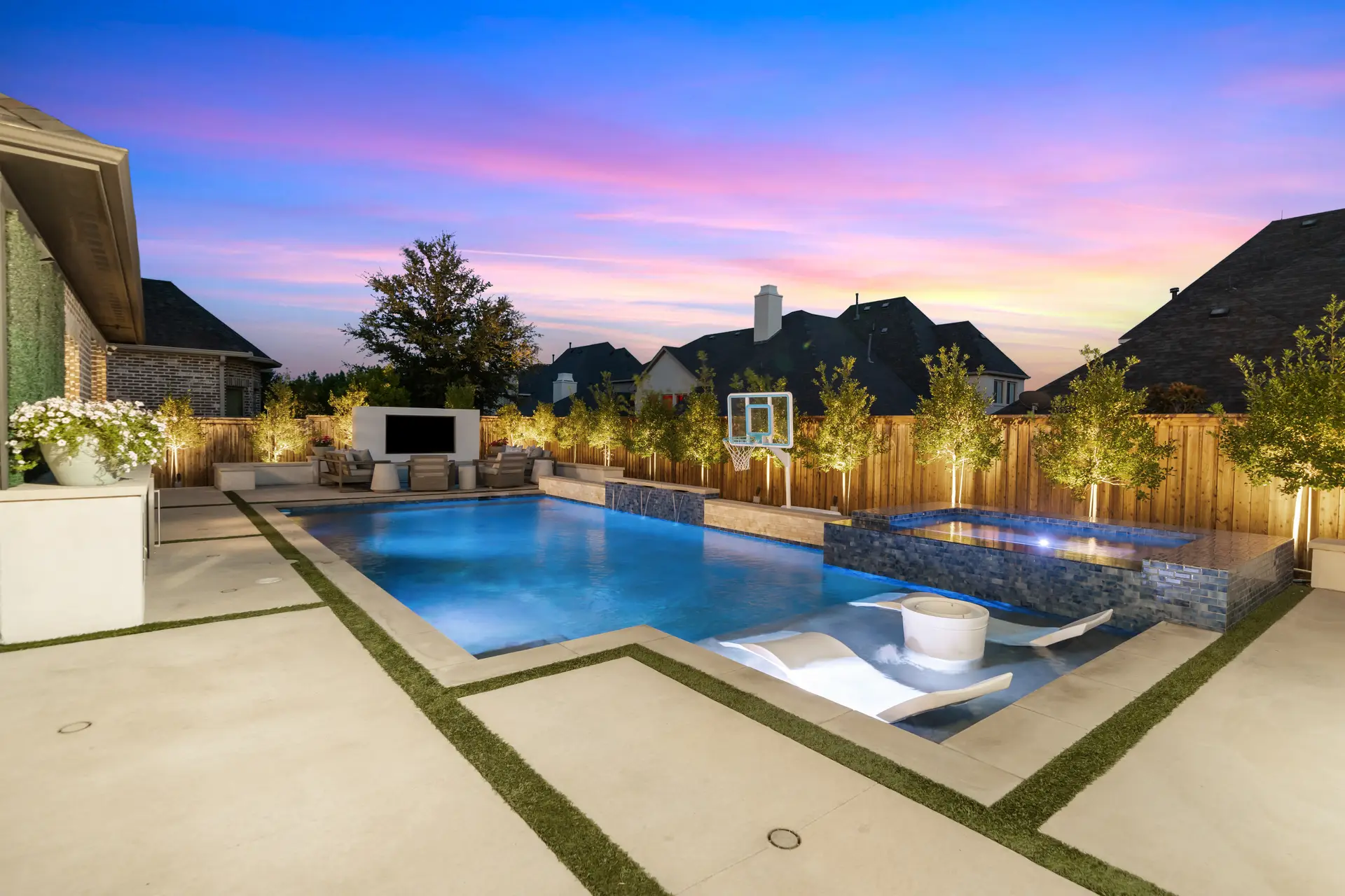 A backyard pool and spa at twilight