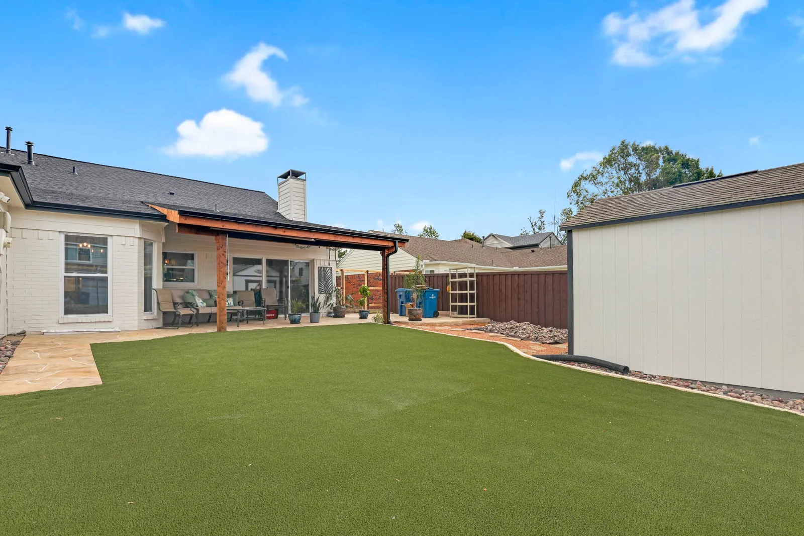 After: backyard with covered patio and turf