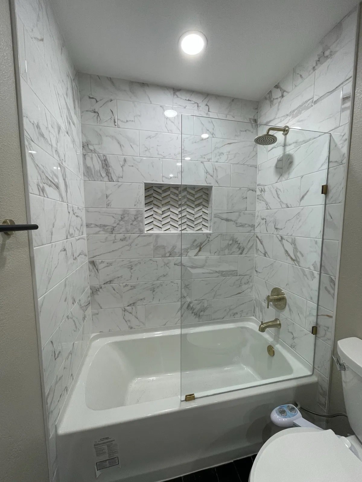 After: tub shower with glass panel and niche