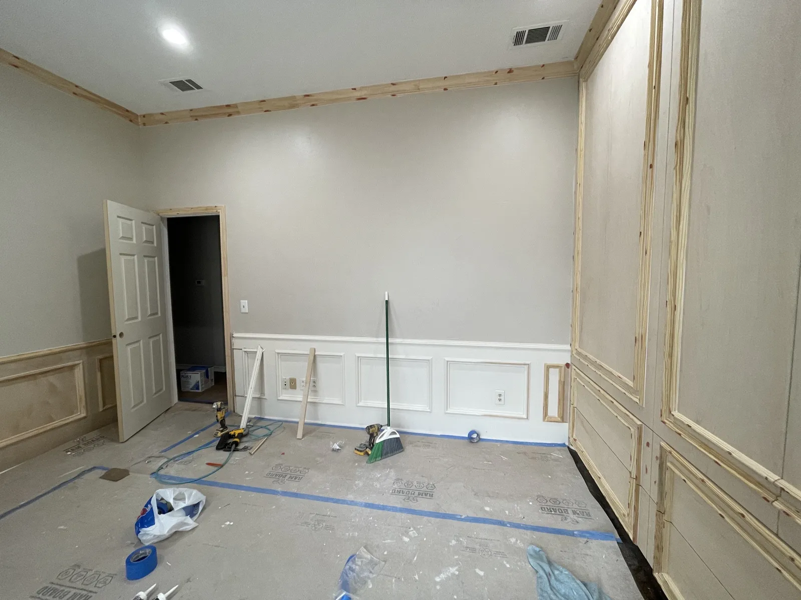 During: wainscot and crown molding installed before paint