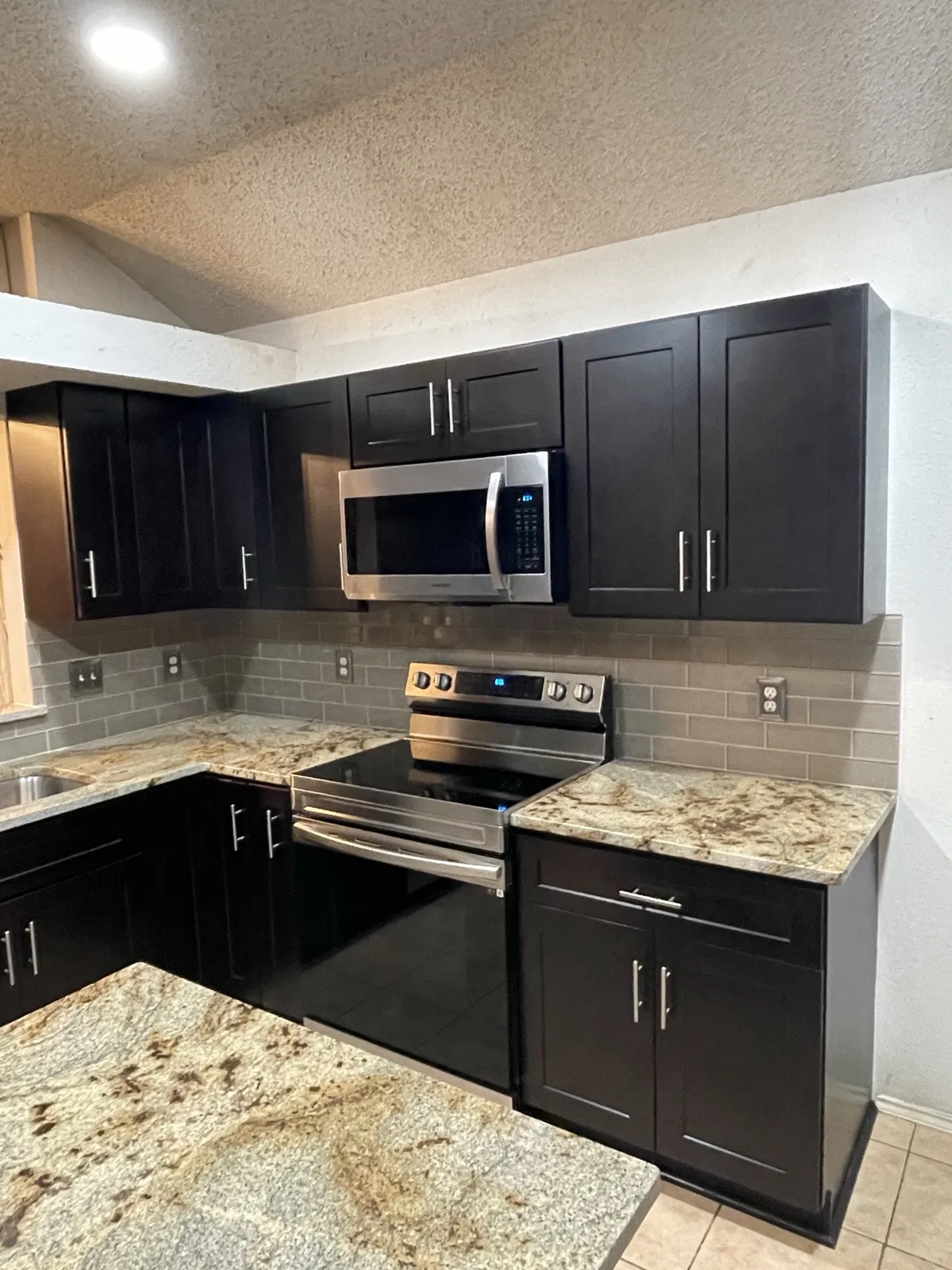 After: espresso upper cabinets and microwave