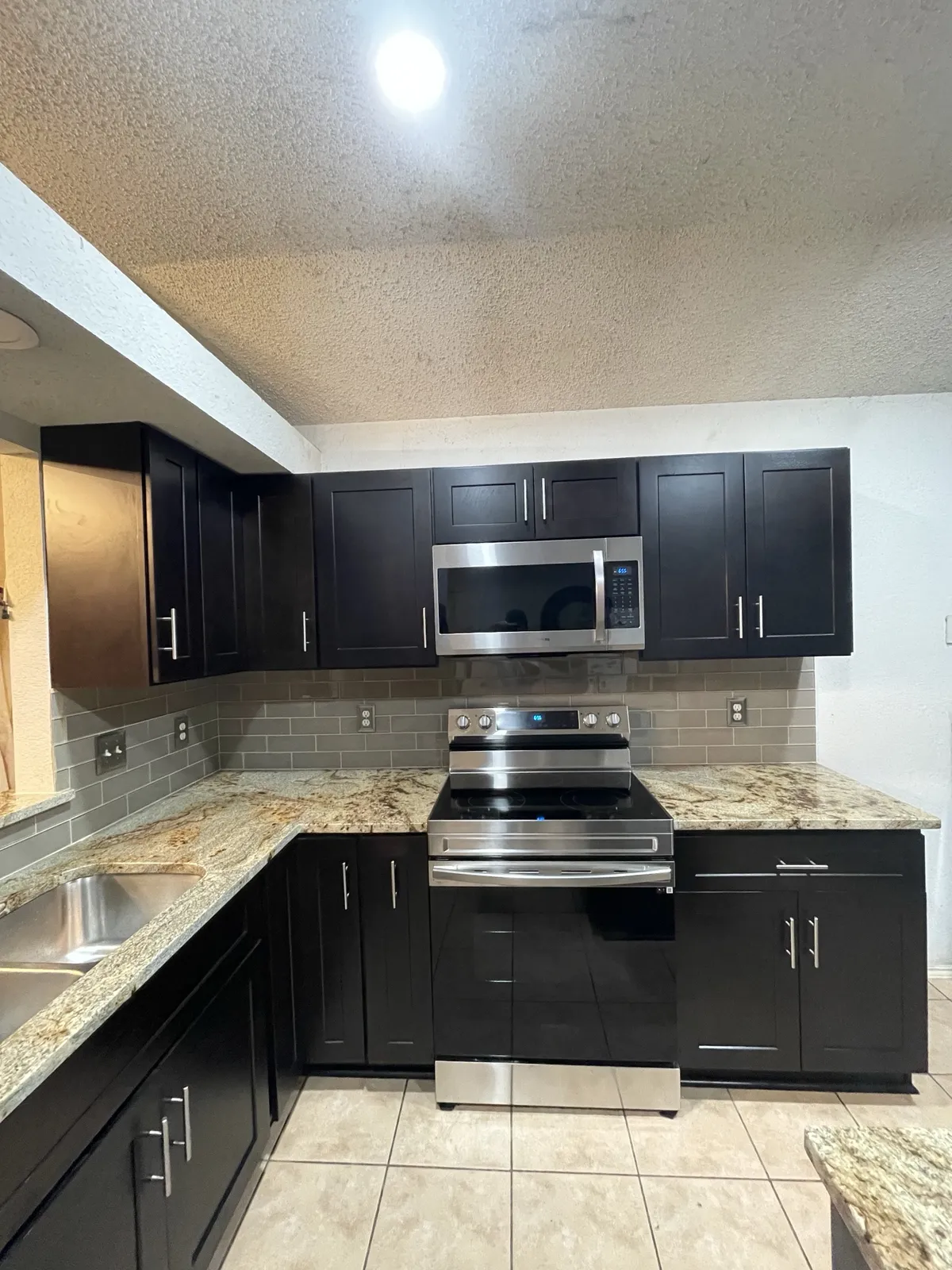 After: range wall granite and tile backsplash