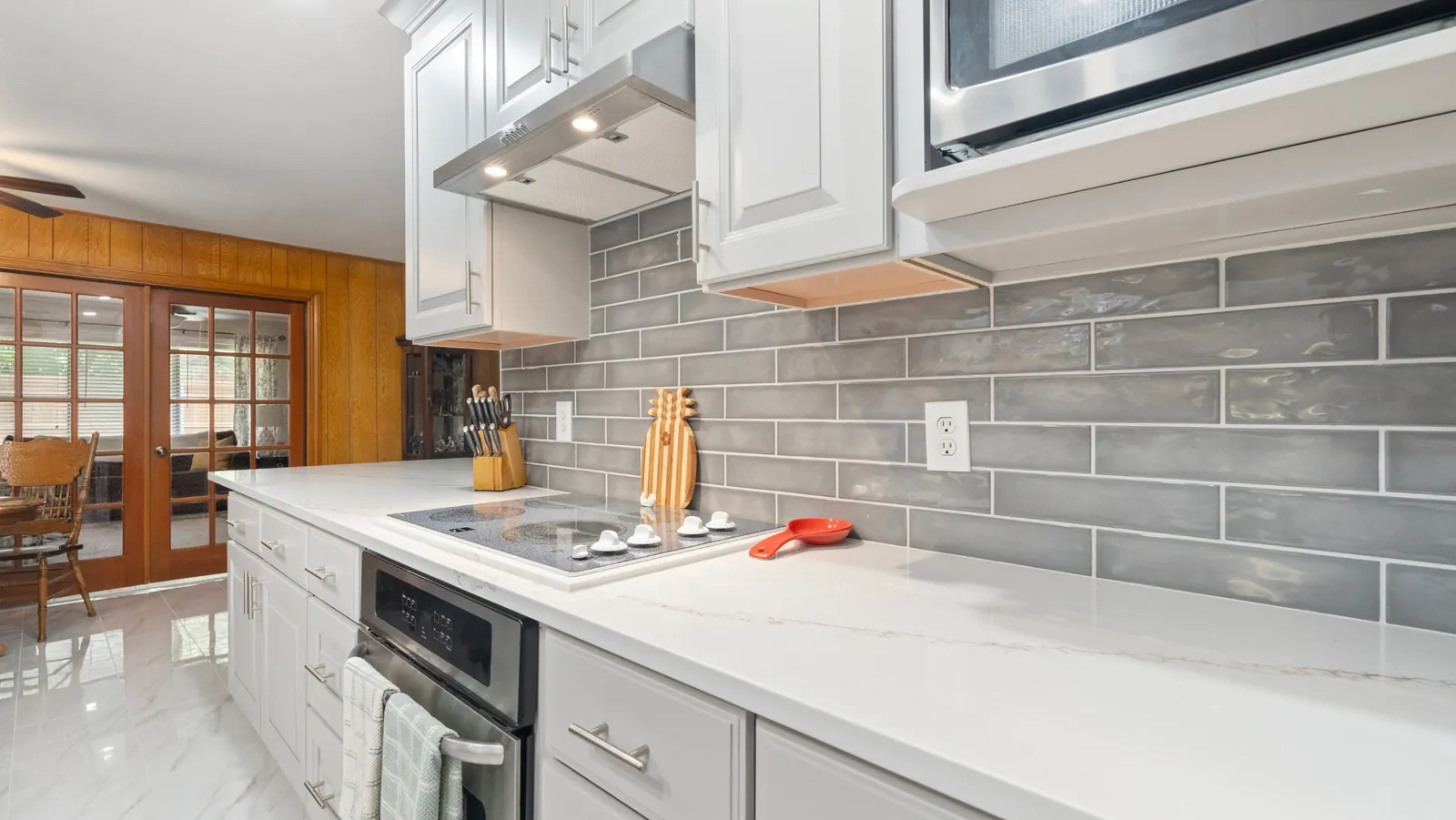 After: backsplash range hood and cooktop
