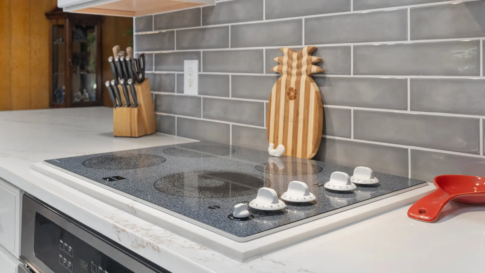 After: cooktop and tile backsplash closeup