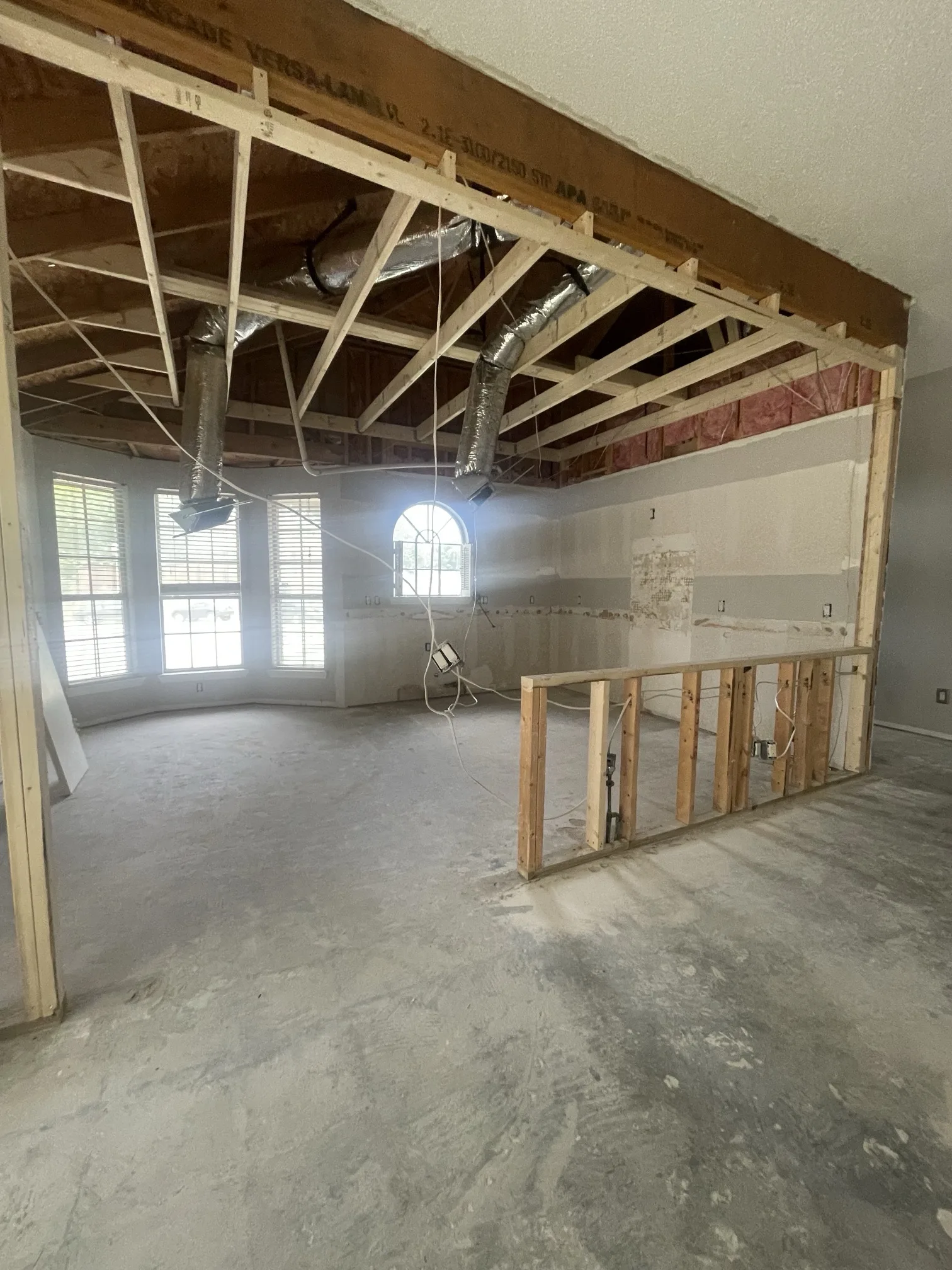 Before: kitchen opened up with walls removed and ceiling framed