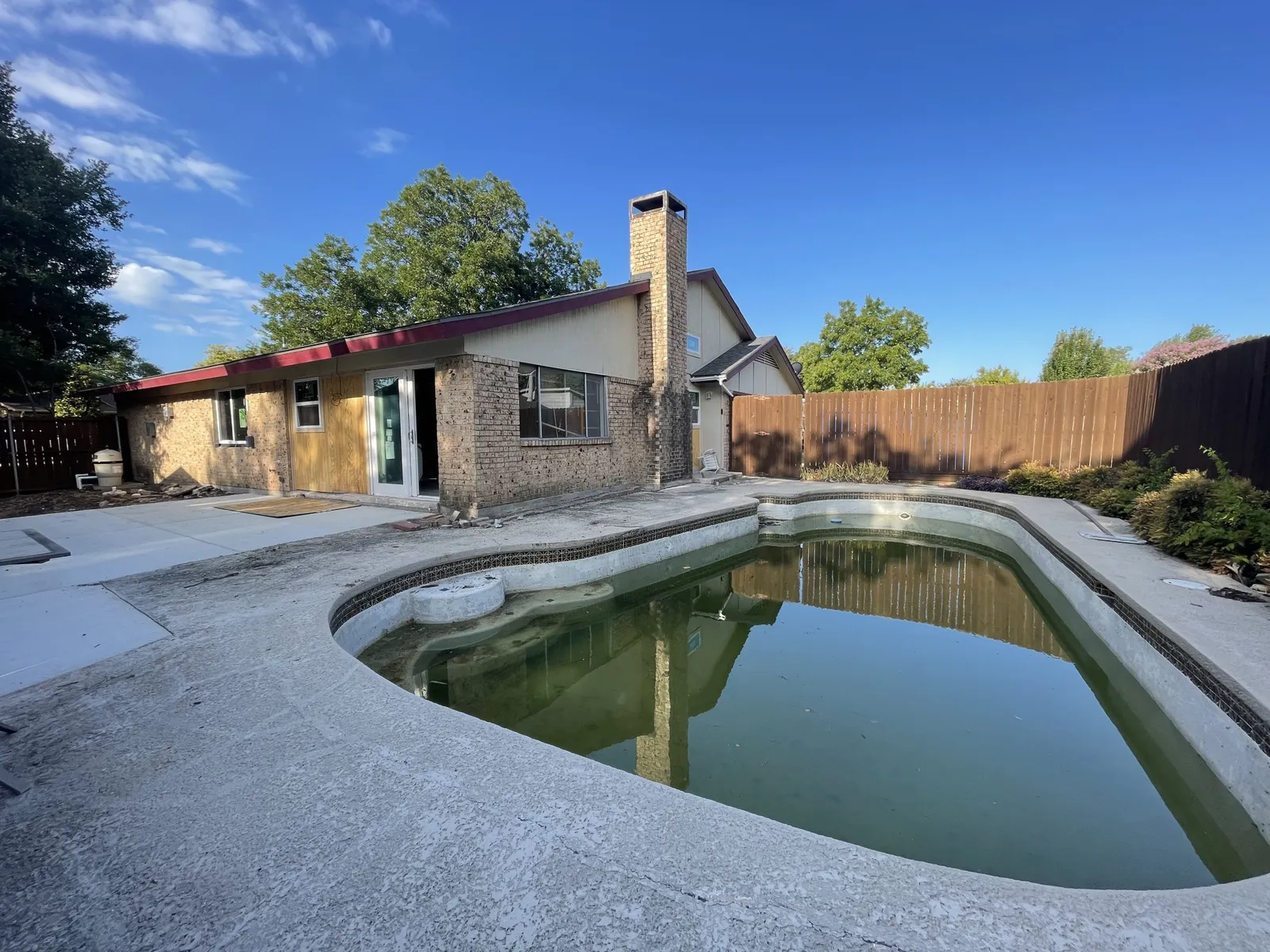 Before: backyard pool and house