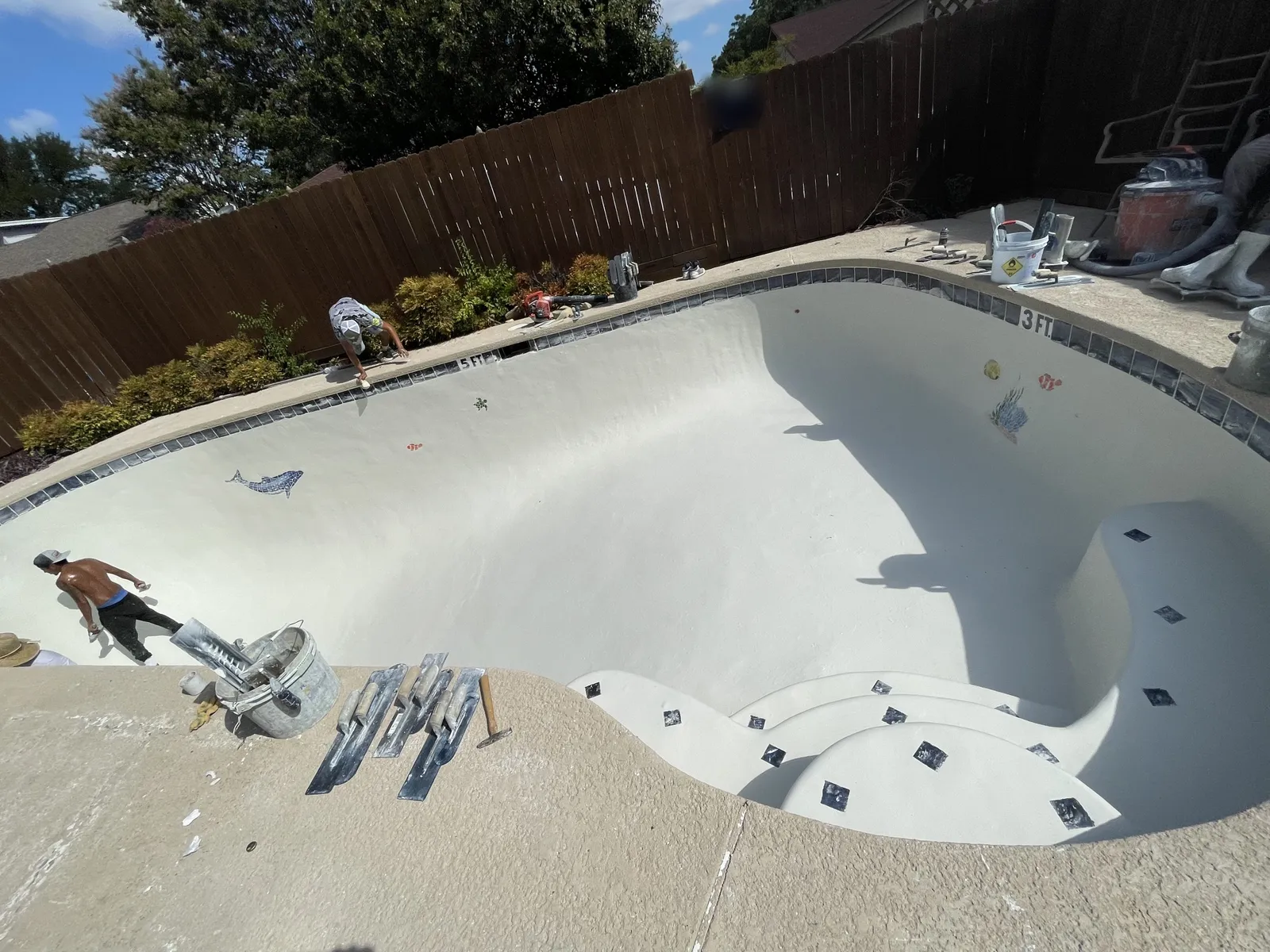 During: new plaster applied across the pool