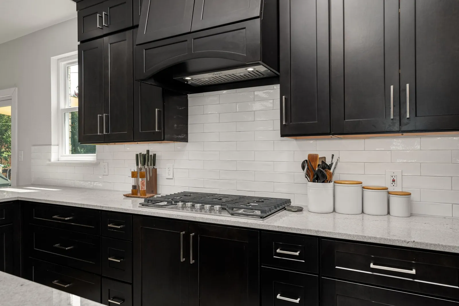 After: backsplash range hood and cooktop