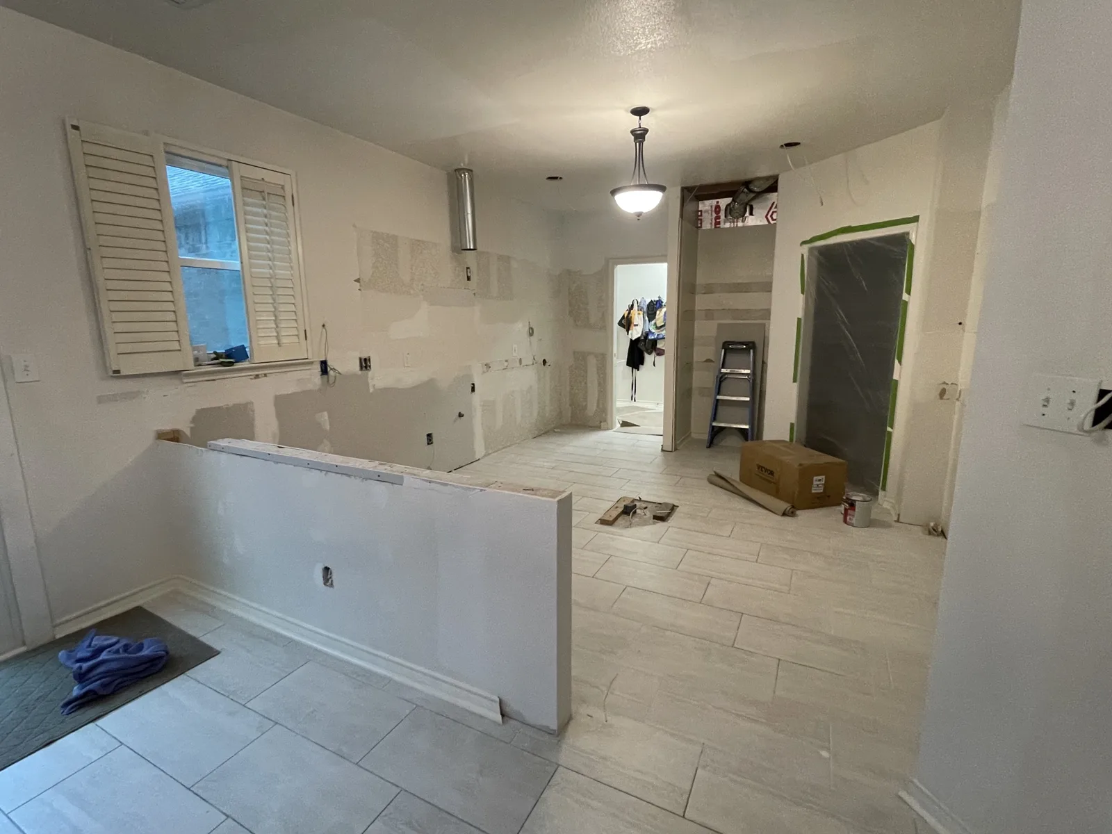 Rowlett kitchen during remodeling with cabinets removed, walls patched and new floor tile installed