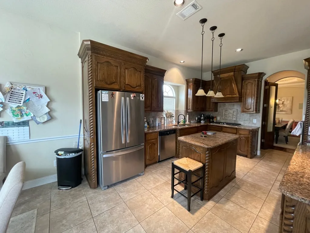 Before: oak cabinets and tile floor